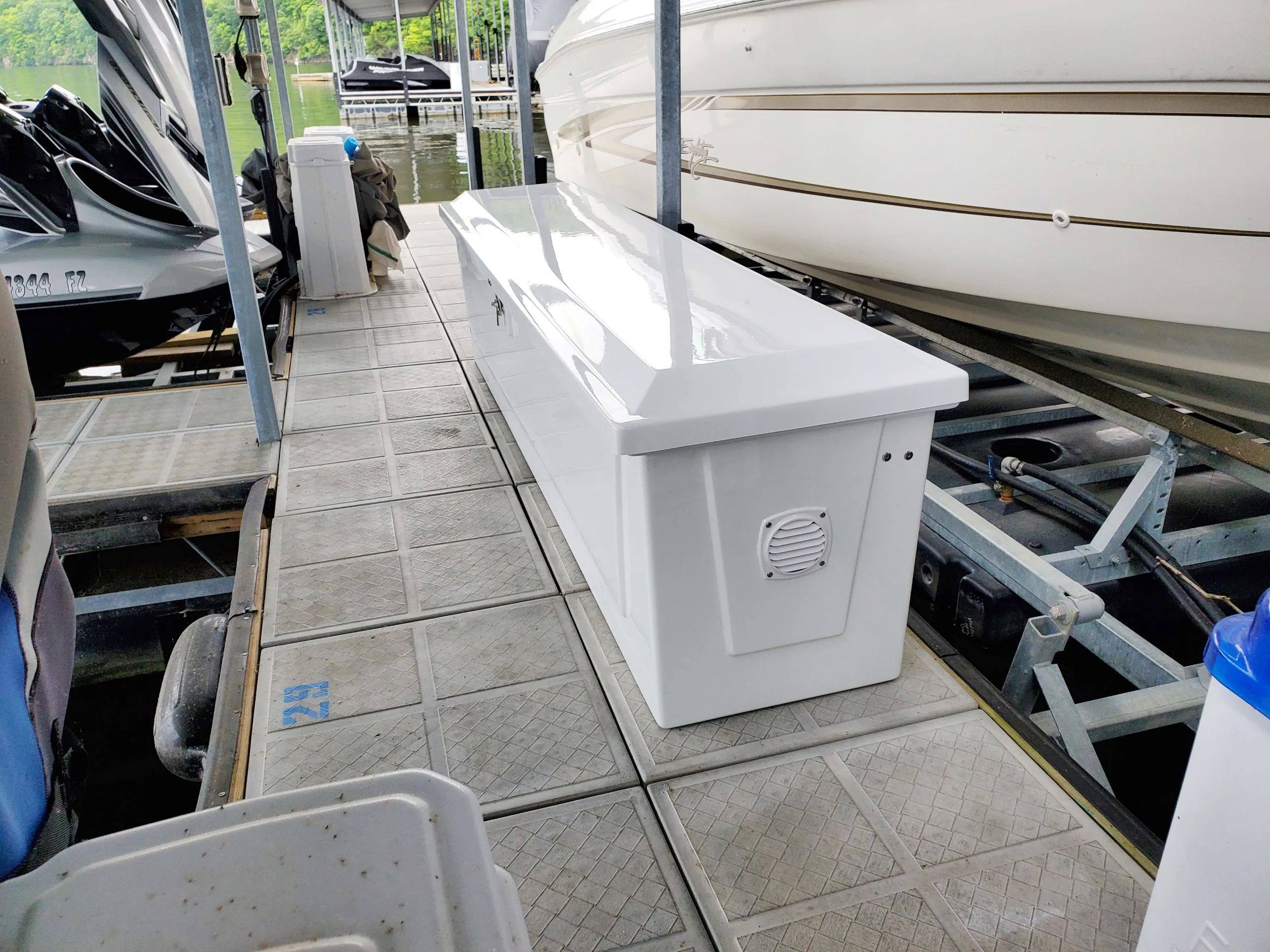 Model 825 dock box with fishing rod holders installed at a marina