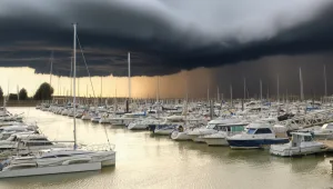 hurricane clouds forming over marina with boats