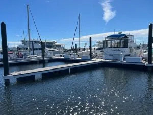 Landscape photo of a boat dock with large boats as part of a luxury marina.
