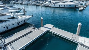 A high quality professional stock photo of a luxury marina with gleaming white floating docks.