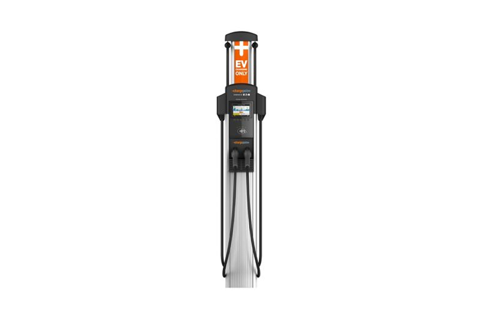 Electric vehicle charging station with multiple connectors and a touchscreen display on top of a tall pedestal.